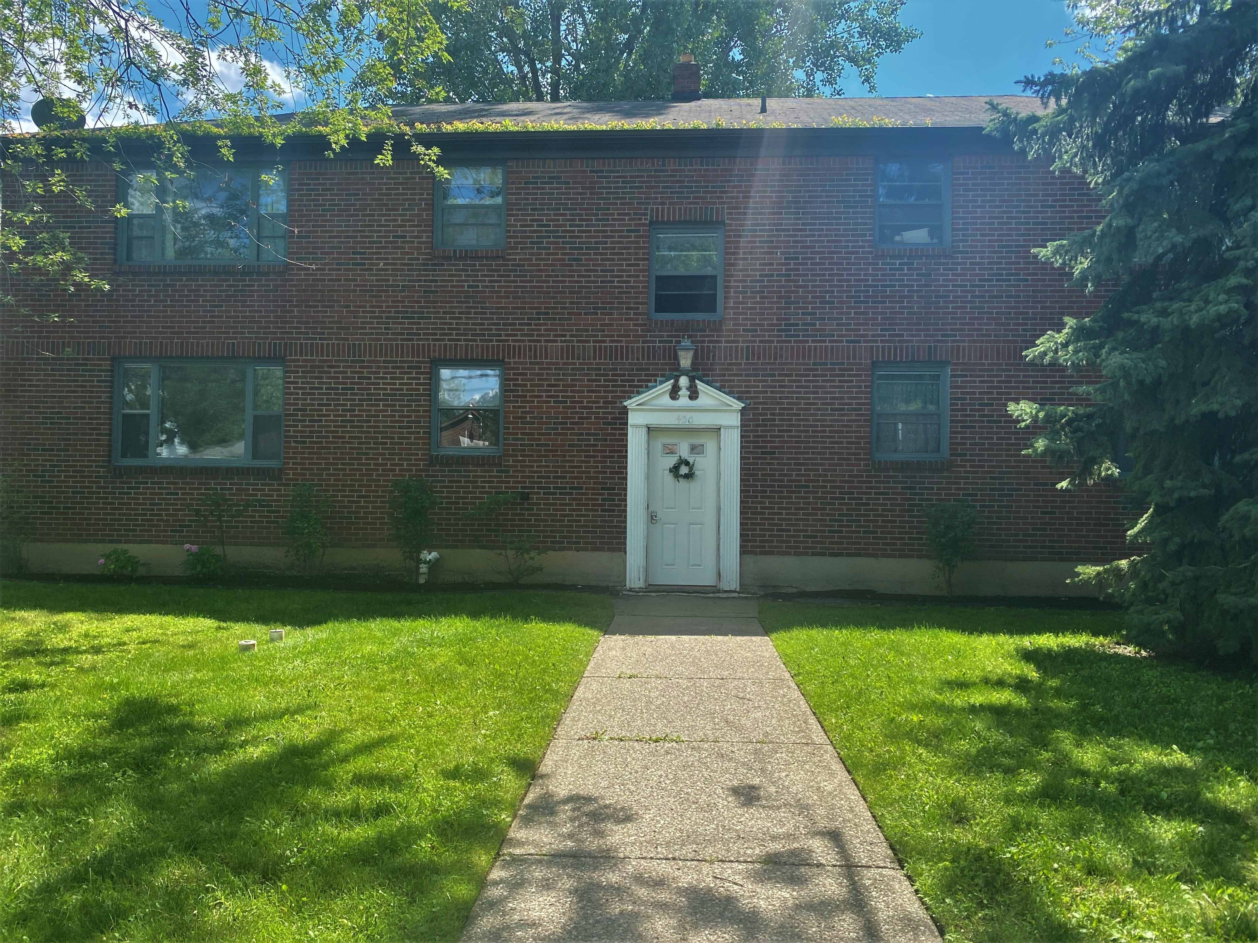 Apartment building with long front walk and white door