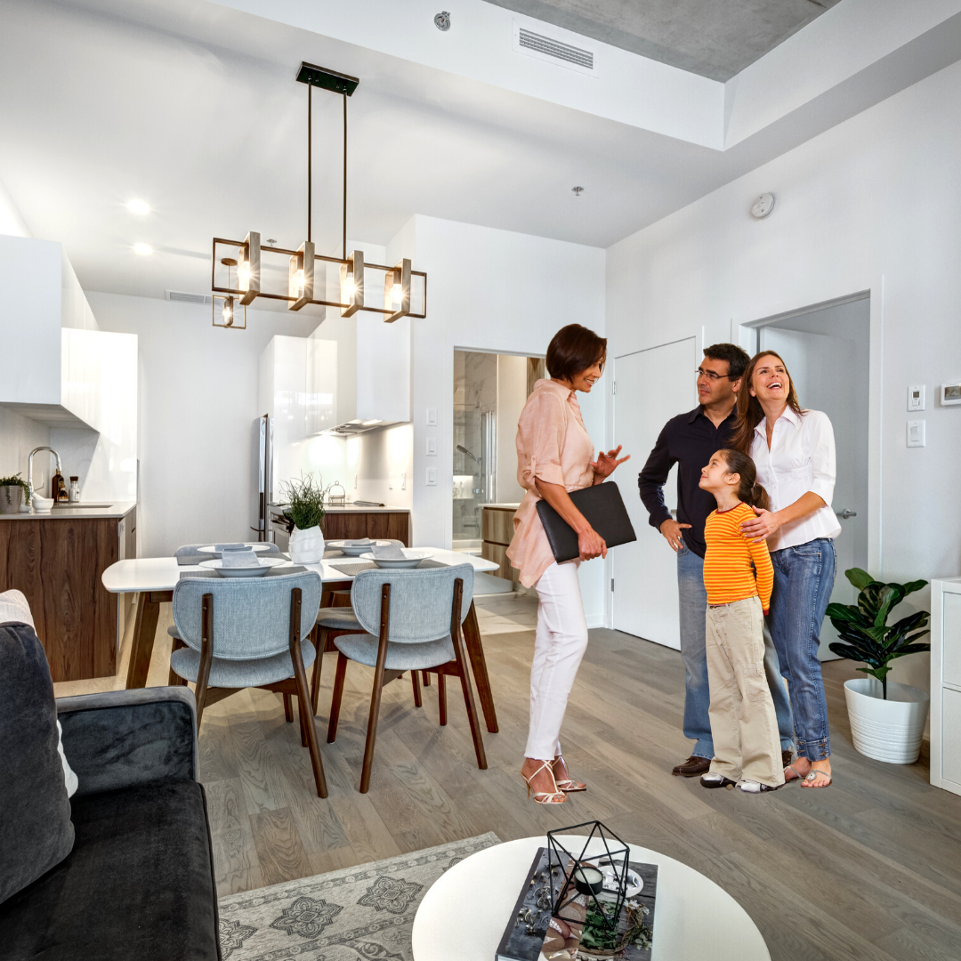 Family standing and talking to realtor in apartment. 